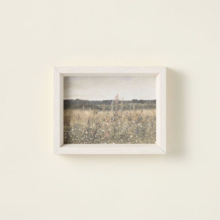 Framed art print of a wildflower field on raw canvas with an antique-style frame.