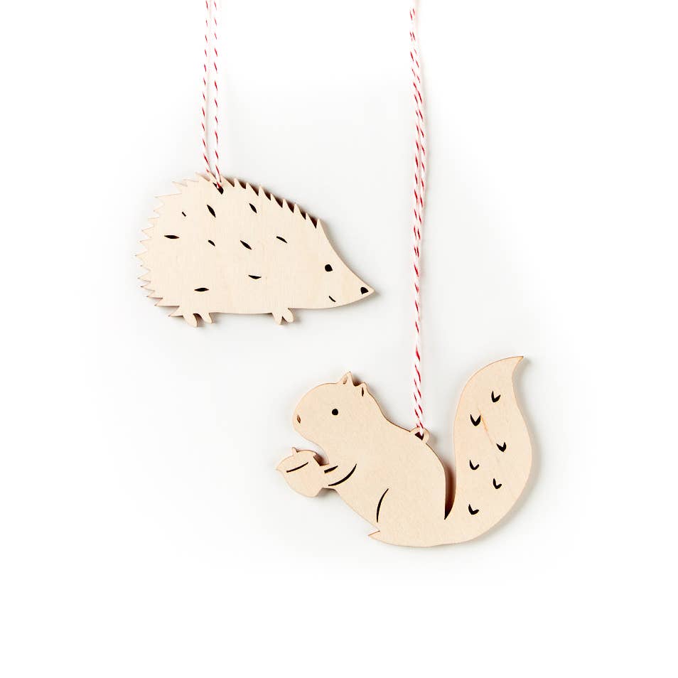 A set of wooden ornaments shaped like squirrels and hedgehogs.
