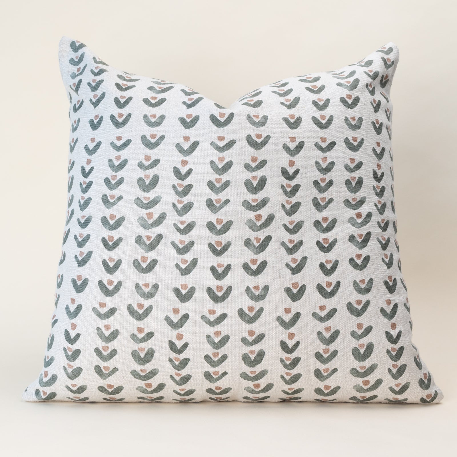A double-sided, nature-inspired pillow cover in a soothing color, laid flat to show the organic motif pattern on oatmeal linen fabric.