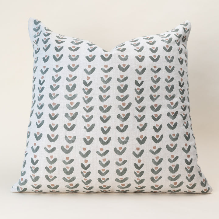 A double-sided, nature-inspired pillow cover in a soothing color, laid flat to show the organic motif pattern on oatmeal linen fabric.