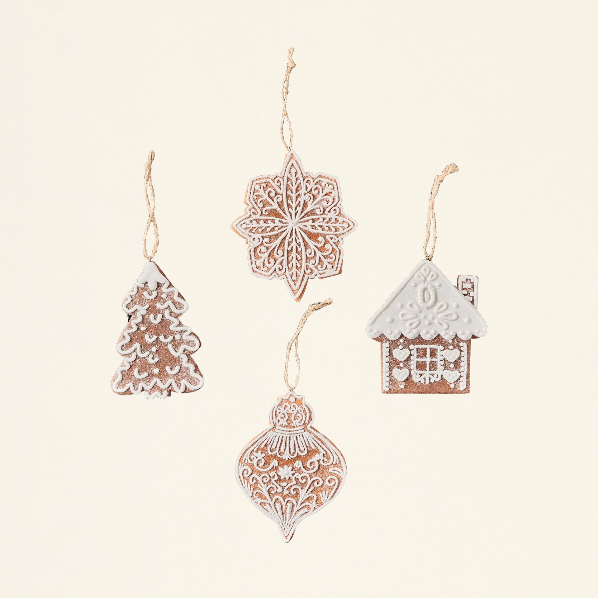 A set of four gingerbread-shaped ornaments made from wheat clay, each with a different pattern.