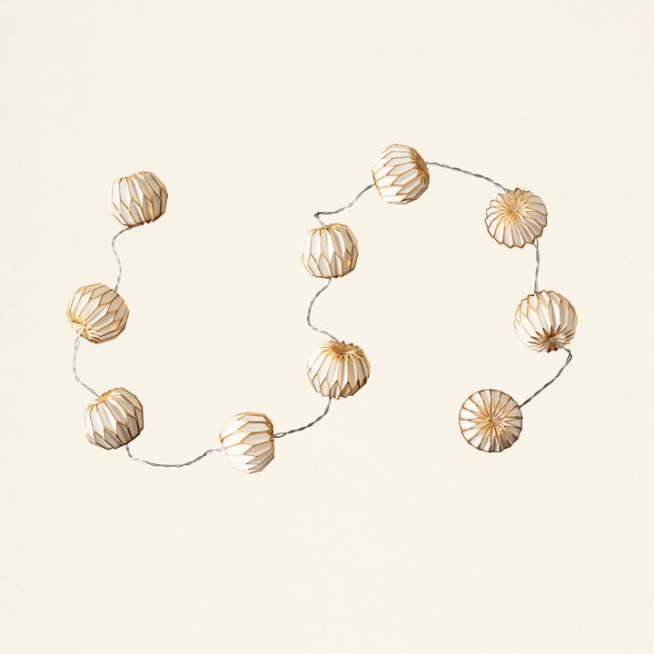 A decorative paper garland with LED lights, in a white and gold color scheme.