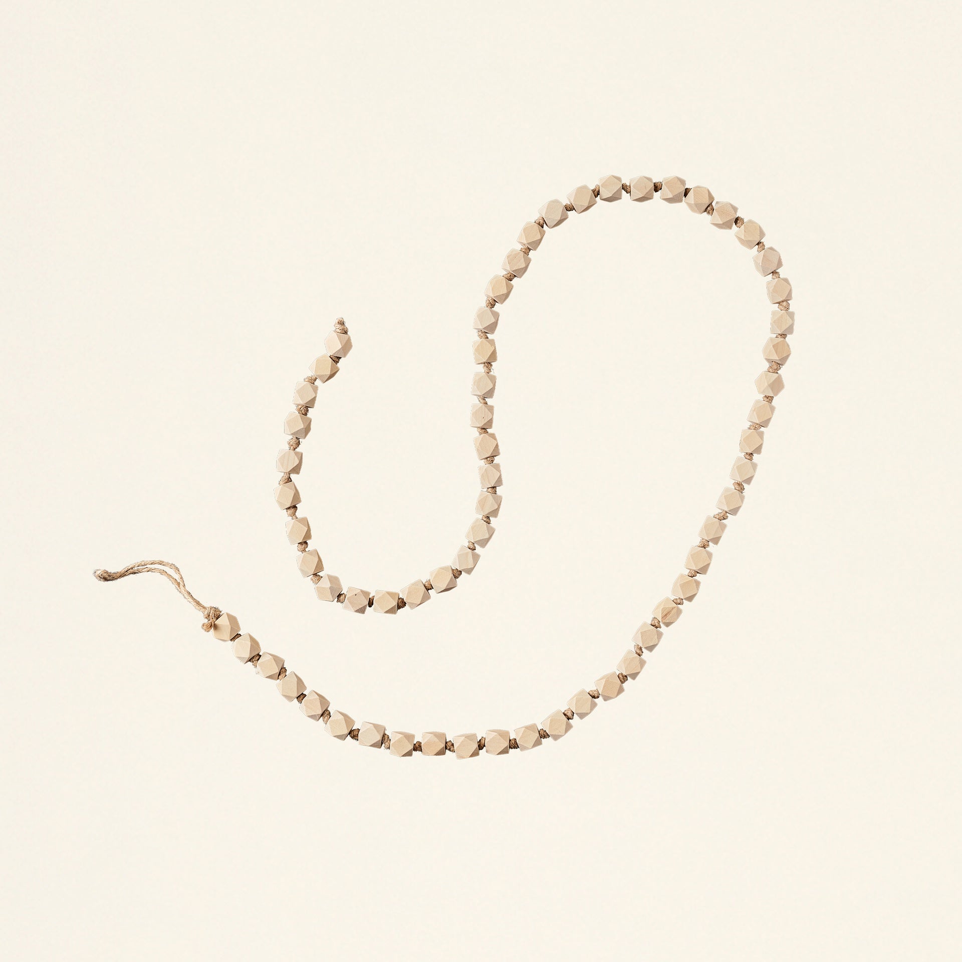 A decorative garland with geometric-shaped wooden beads.