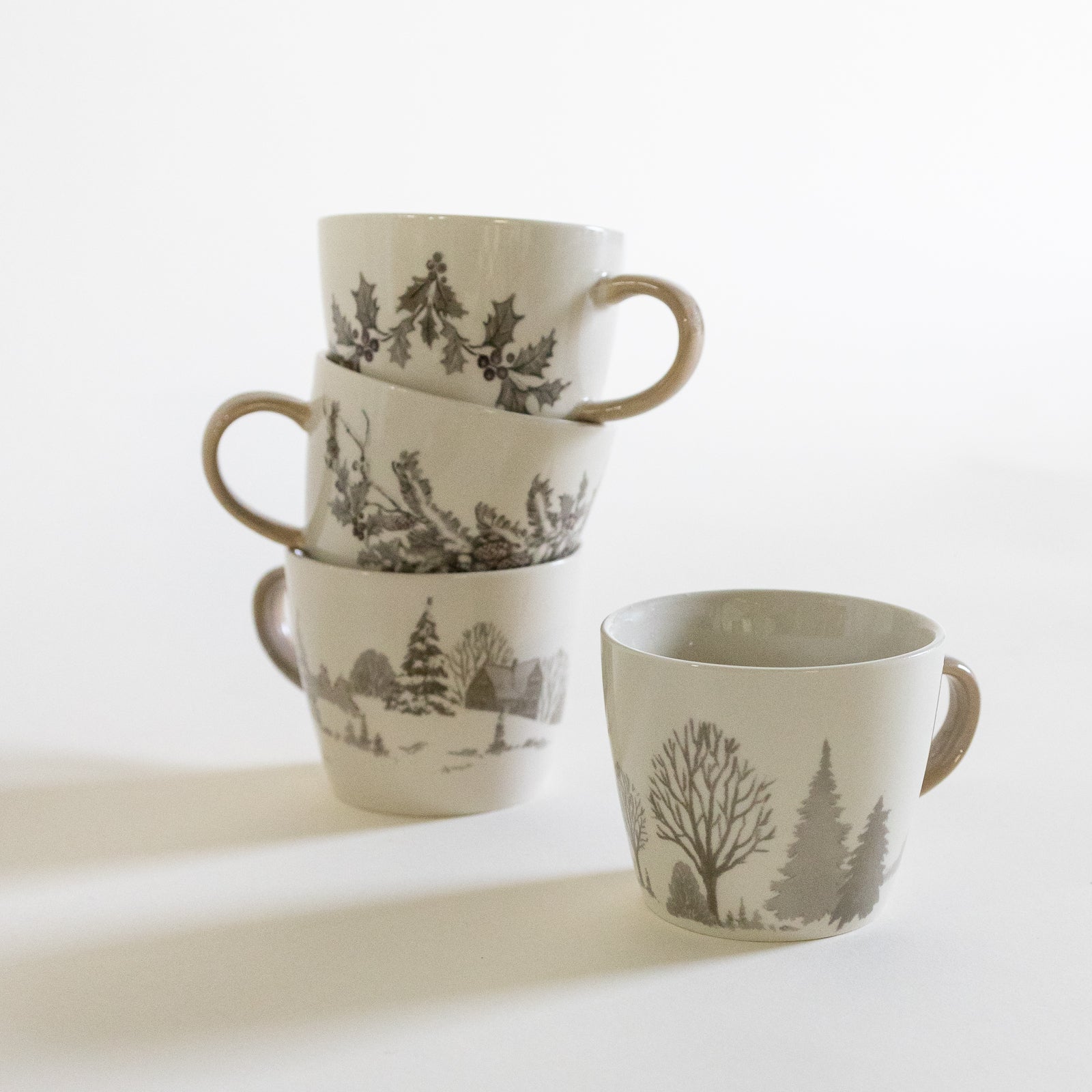 A set of vintage-inspired stoneware cups with a handcrafted, rustic feel.