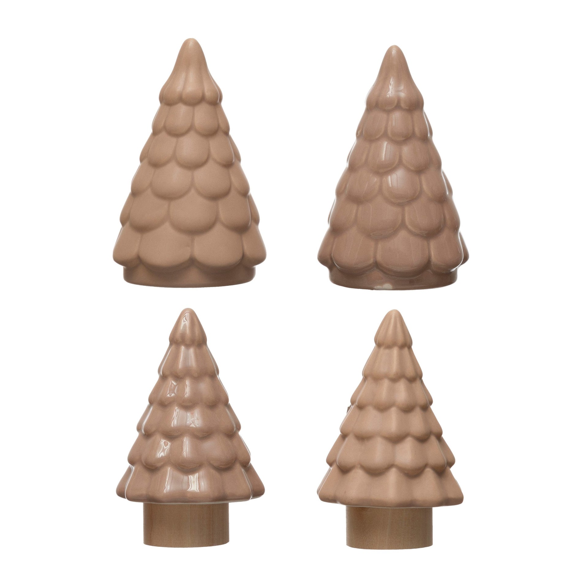 A set of four small stoneware trees in a neutral taupe color.